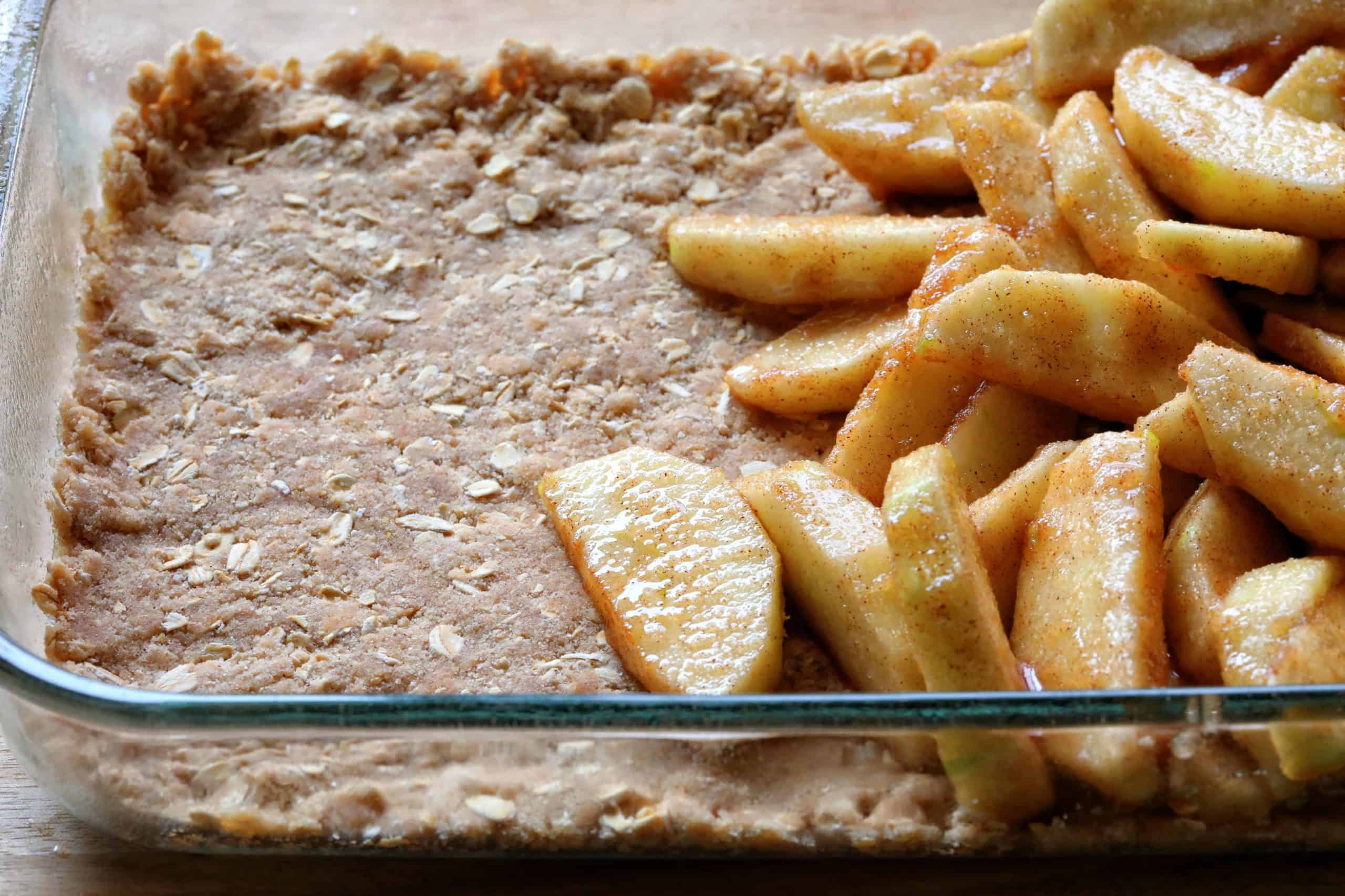 This is the only Apple Crisp recipe you will ever need!! HUGE flavor! Apple Crisp, Apple Crumble, perfect apple crisp, how to make apple crisp, easy apple crisp, i am baker, best apple crisp, easy apple crisp, award wining apple crisp, i am baker, iambaker, apple crumble recipe Pan Showing Bottom Layer of Double Crisp Apple Crisp with Apples on Top.