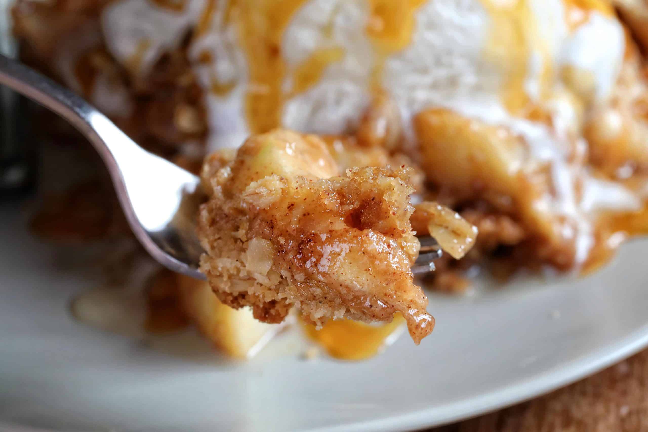 This is the only Apple Crisp recipe you will ever need!! HUGE flavor! Apple Crisp, Apple Crumble, perfect apple crisp, how to make apple crisp, easy apple crisp, i am baker, best apple crisp, easy apple crisp, award wining apple crisp, i am baker, iambaker, apple crumble recipe Apple Crisp Bite on a Fork with Ice Cream and Caramel.