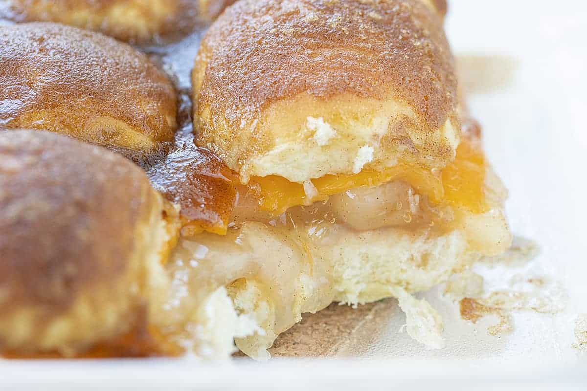 Sweet and scrumptious as apple pie with just the smallest hint of something different. The cheddar seems to lose its potent flavor and perfectly compliment the apple and cinnamon! Apple Pie Cheddar Sliders, Apple Pie Sliders, Dessert Sliders, Apple Cheese Sliders, Sliders Recipe, Recipes, iambaker, i am baker Apple Cheddar Sliders in a Pan