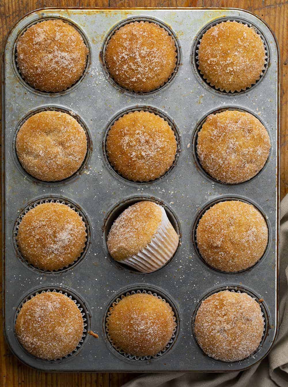 Apple Cider Muffins are full of apple flavor with apple pie spice and apple cider and are the perfect treat to have with a cup of coffee, as a dessert, or even to just satisfy your sweet tooth! apple cider muffins, apple cider, apple pie spice, apple desserts, baking, apple muffins recipe, iambaker, i am baker Overhead of Apple Cider Muffins in Pan