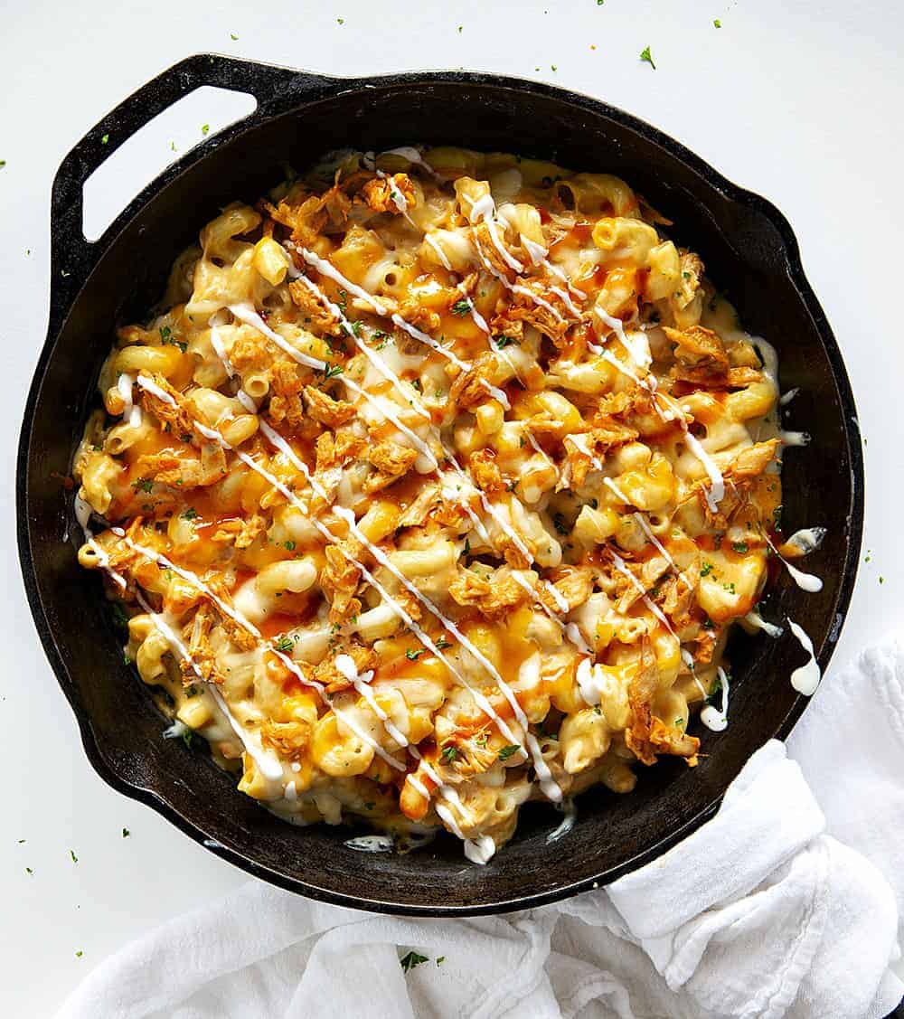 Buffalo Chicken Macaroni and Cheese is a macaroni and cheese that even adults will crave! It's buffalo chicken and cheesy noodles make for a satisfying and addicting dish! homemade macaroni and cheese, buffalo chicken macaroni and cheese, homemade buffalo sauce, home made ranch dressing, rotisserie chicken, iambaker, dinner recipes Buffalo Macaroni and Cheese in a Skillet