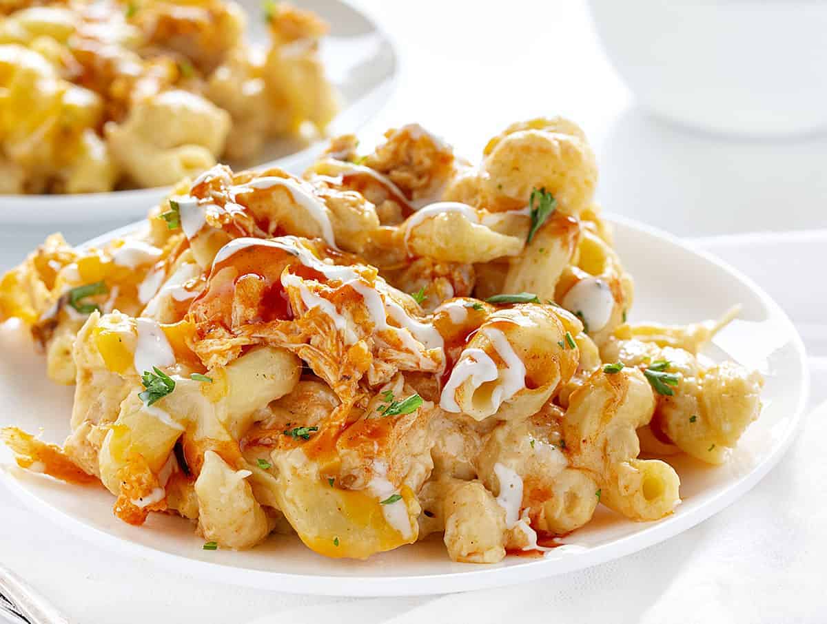 Buffalo Chicken Macaroni and Cheese is a macaroni and cheese that even adults will crave! It's buffalo chicken and cheesy noodles make for a satisfying and addicting dish! homemade macaroni and cheese, buffalo chicken macaroni and cheese, homemade buffalo sauce, home made ranch dressing, rotisserie chicken, iambaker, dinner recipes Plate of Buffalo Chicken Macaroni and Cheese