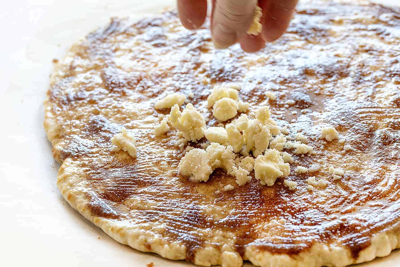 This recipe has been TESTED and PERFECTED! A glorious cinnamon-sugar dessert pizza covered in the best sweet glaze. A fan favorite! cactus bread, copycat cactus bread, dessert pizza, crispy cinnamon dessert, dessert, baking, recipes, iambaker Sprinkling Crumble on Cactus Bread