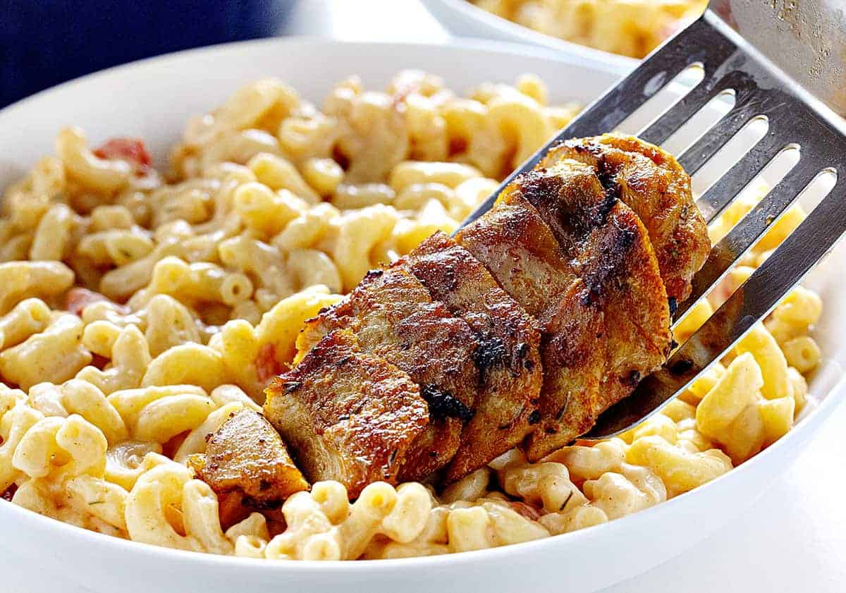 Cajun Chicken Macaroni and Cheese is a hearty, spicy, cheesy dish that will have you and your guests reaching for seconds! Cajun chicken macaroni and cheese, iambaker, dinner recipes, macaroni and cheese, homemade macaroni and cheese, cajun seasoning, homemade cajun seasoning, dinner, cajun chicken Adding Chicken to Cajun Chicken Macaroni and Cheese