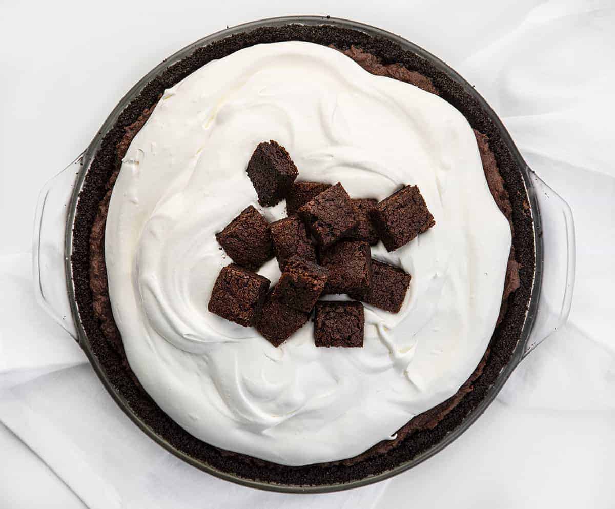 Death By Chocolate Pie is a chocolate lover's dream with its Oreo cookie crust and a creamy chocolate filling loaded with homemade brownie pieces and chocolate whipped cream. Death By Chocolate Pie - Chocolate Brownie Pie, Chocolate Pie, Brownie Pie, Chocolate, Pie, Baking, Brownie Pie, i am baker, Christmas, New Years, i am baker, recipes Death By Chocolate Pie - Chocolate Brownie Pie from Overhead