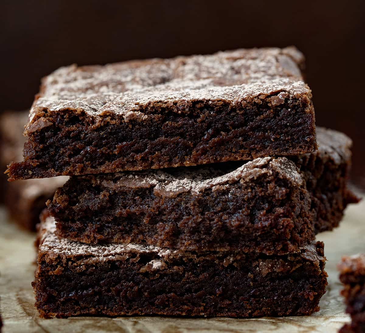 Crazy Brownies are moist brownies that are crazy good and just as crazy to make since they are made with NO milk, eggs, or butter! No frosting is needed, but you could sprinkle some confectioners sugar, or walnuts on top for a little bit of sweet crunch in each chocolatey bite. They are based on my Depression Cake, also known as Crazy Cake or Wacky Cake! Chocolate Brownies Stacked on Top of Each other.