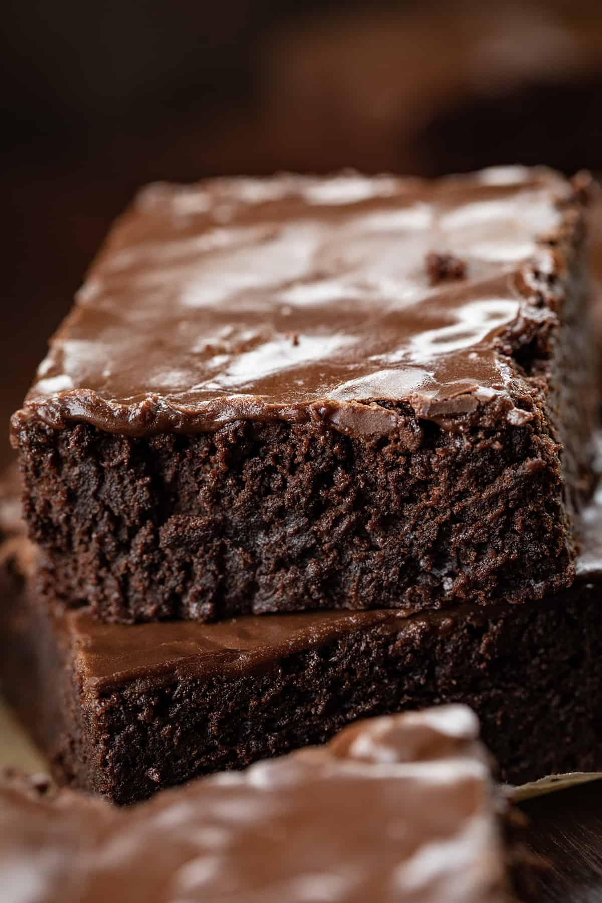 This is the ONLY true Double Fudge Brownie!! Once you take a bite you'll know exactly why I can say that. This Double Fudge Brownie has a moist, luscious texture with an intense chocolate flavor in every deliciously chewy and fudgy bite! Although these brownies can stand on their own, I added a brownie frosting to make this treat even more decadent. Close up of a Cut Double Fudge Brownie Showing the Texture.
