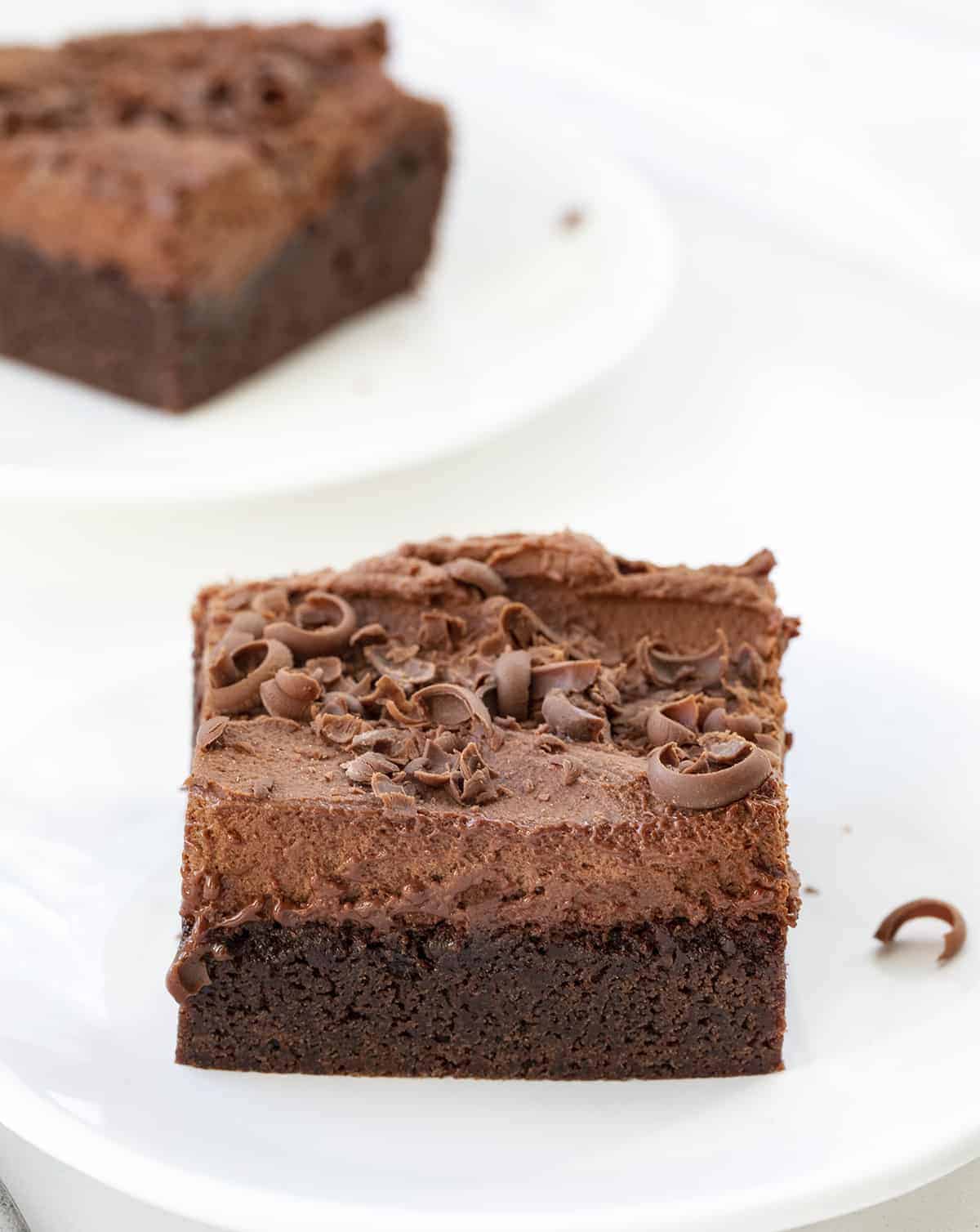Chocolate Mousse Brownies are homemade brownies baked and topped with creamy chocolate mousse and chocolate curls. Brownies, Brownie Recipe, Chocolate Brownie Recipe, Chocolate Mousse Brownies, How to Make Mousse, Chocolate Mousse, Fudgy Brownies, Chocolate Brownies, Dessert, i am baker, iambaker Two Slices of Chocolate Mousse Brownies