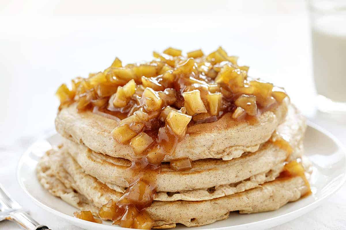 Light and fluffy apple pancakes topped with an apple topping make these Spiced Apple Pancakes too good to pass up! spiced apple pancakes, homemade apple pie spice, apple pie spice, apple spice, iambaker, comfort food, hot breakfast, pancakes, johnnycakes, hotcakes, breakfast, weekend breakfast Stack of Spiced Apple Pancakes