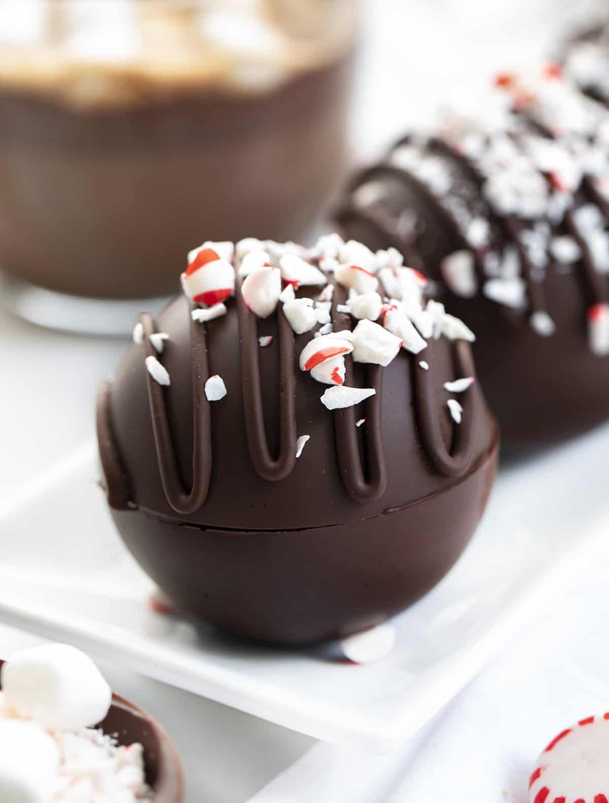 These Peppermint Hot Cocoa Bombs are not only amazingly delicious, but they are fantastic gift idea! With winter here, it’s time for hot drinks! It seems like peppermint also goes hand in hand with the coldest months of the year. When you add a bomb to a cup or mug of hot milk, it ‘explodes’, giving you a delicious cup of peppermint hot cocoa! Close up of Peppermint Hot Cocoa Bombs.