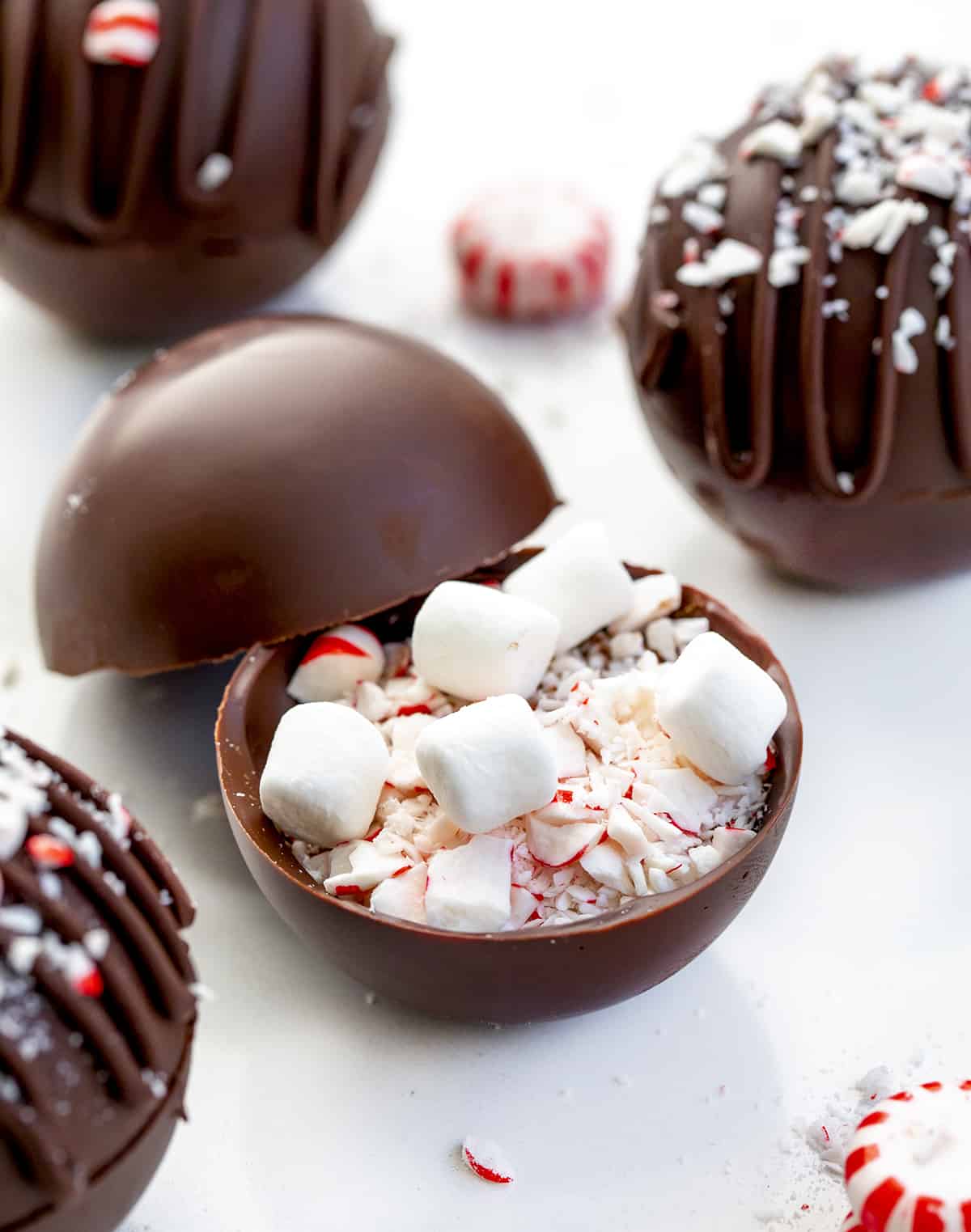These Peppermint Hot Cocoa Bombs are not only amazingly delicious, but they are fantastic gift idea! With winter here, it’s time for hot drinks! It seems like peppermint also goes hand in hand with the coldest months of the year. When you add a bomb to a cup or mug of hot milk, it ‘explodes’, giving you a delicious cup of peppermint hot cocoa! A Peppermint Cocoa Bomb with the Filling Before it is Sealed Closed with Chocolate.