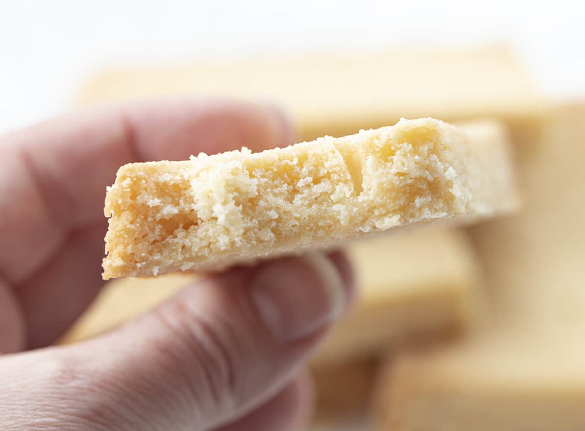 Shortbread Cookies are traditional Scottish biscuits with a buttery taste that have a soft and crumbly texture. The Best Shortbread Cookies, Authentic Shortbread Cookies, Shortbread Cookies, Shortbread Pie Crust, How to Make Shortbread, Cookies, Baking, i am baker, iambaker, recipes Hand Holding Shortbread Cookie