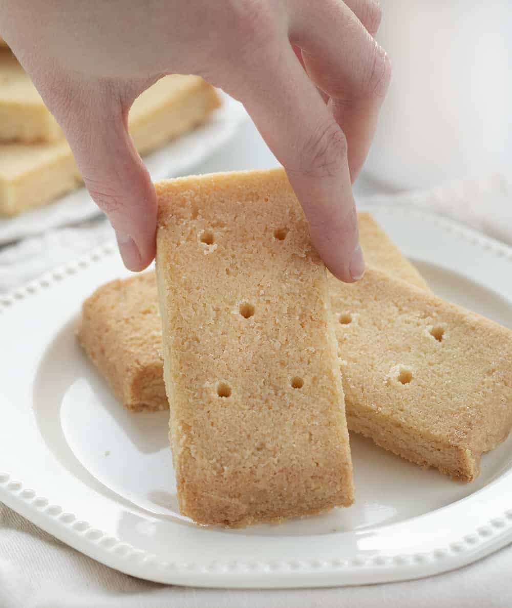 Shortbread Cookies are traditional Scottish biscuits with a buttery taste that have a soft and crumbly texture. The Best Shortbread Cookies, Authentic Shortbread Cookies, Shortbread Cookies, Shortbread Pie Crust, How to Make Shortbread, Cookies, Baking, i am baker, iambaker, recipes Hand Holding Shortbread Cookie