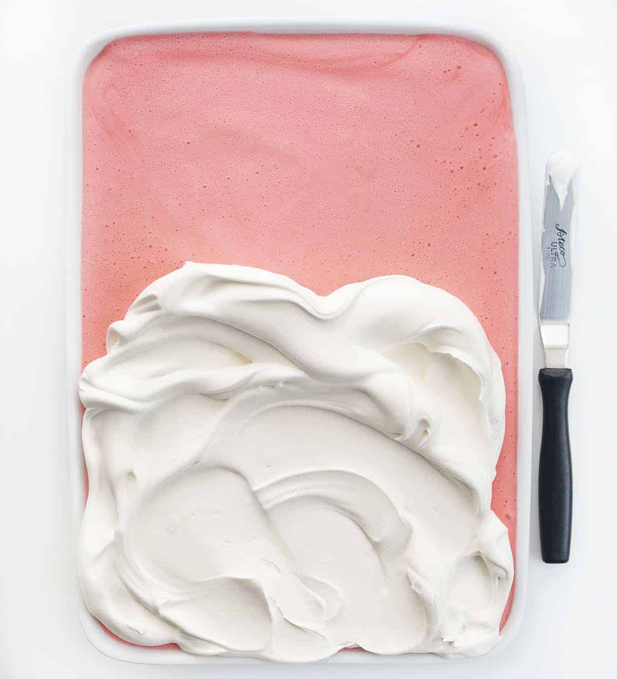 Strawberry Icebox Cheesecake is a light and fluffy no-bake dessert with fresh strawberries and a graham cracker crust. Strawberry Jello Cake, Woolworth Cake, Icebox Cake, Strawberry Woolworth Icebox Cake, Summer Cake, Refrigerator Cake, No Bake, Dessert, Strawberry Dessert, recipes, i am baker, iambaker Adding Whipped Cream to Strawberry Icebox Cheesecake