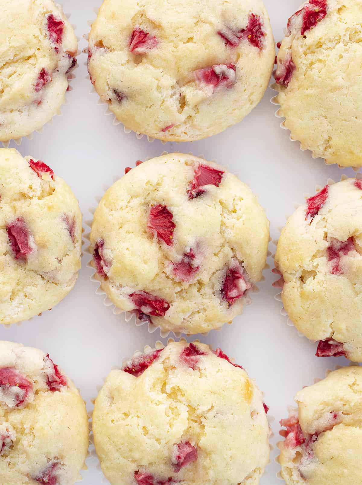 Strawberry Muffins are soft and fluffy muffins made with fresh strawberries for a perfectly sweet and refreshing treat. Muffins, Muffin Recipes, Breakfast, Strawberry Muffins, Real Strawberry Muffins, Baking, i am baker, iambaker, strawberry cupcake Overhead of Real Strawberry Muffins Together on Counter