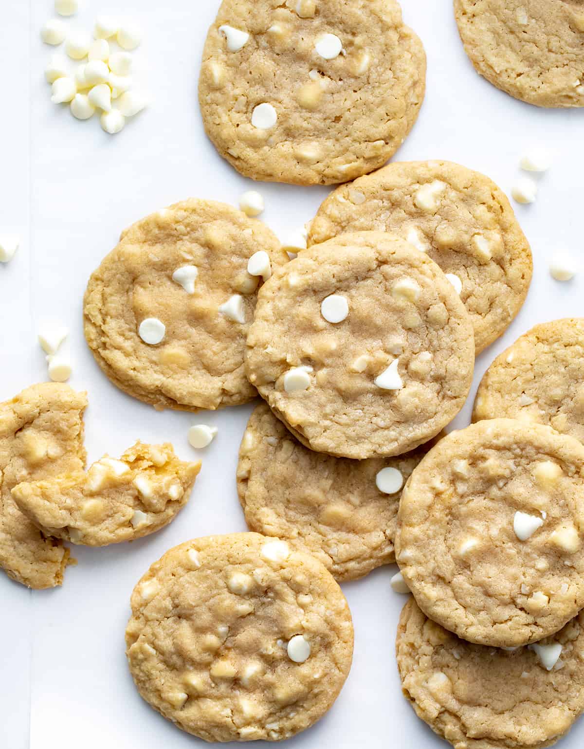 White Chocolate Macadamia Nut Cookies have the rich, buttery flavor of macadamia nuts and the sweet creaminess of white chocolate. These soft, chewy cookies are loaded with white chocolate chips and chopped macadamia nuts for the perfect balance of flavors, great for any occasion! White Chocolate Macadamia Nut Cookies with White Chocolate Chips and a Broken in Half Cookie.